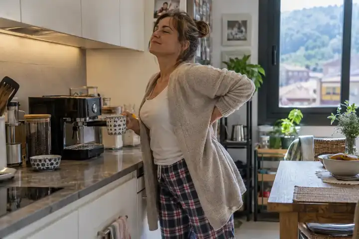 Mujer en casa cambiando de postura